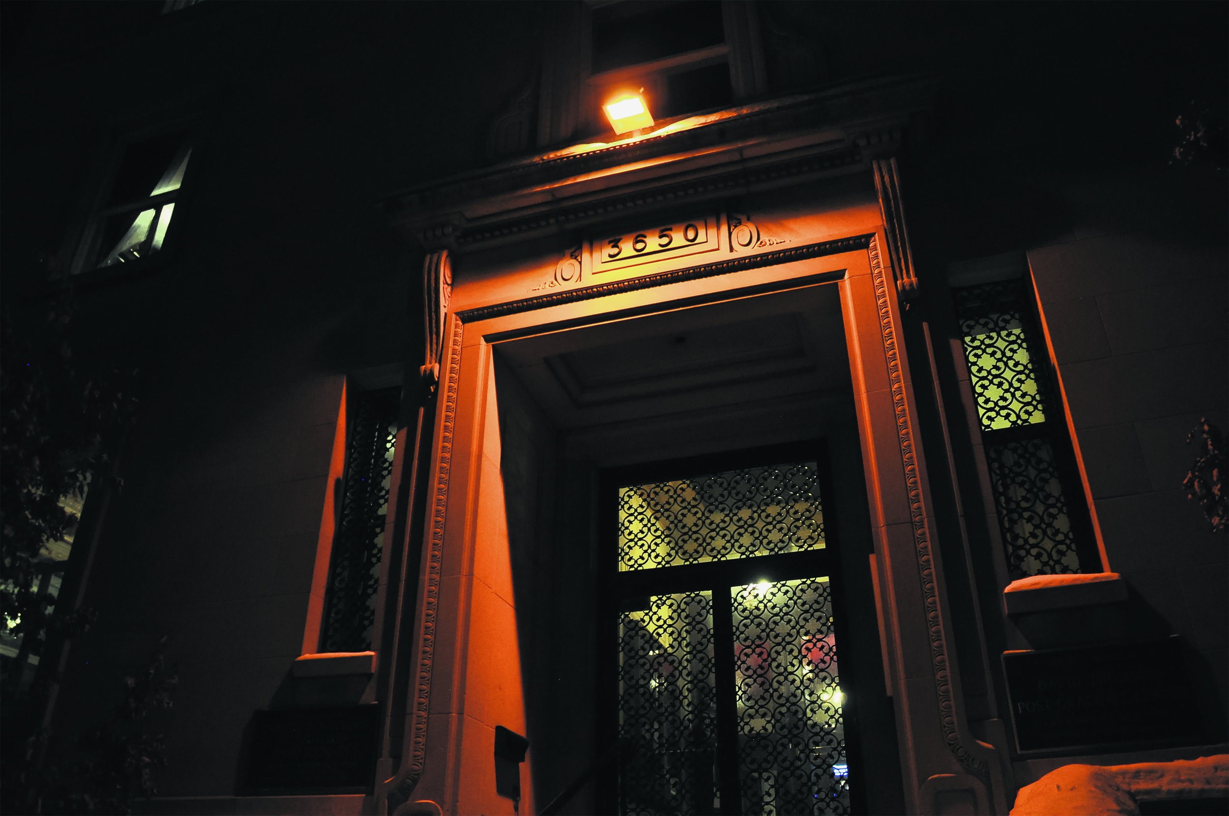 The entrance to the Thomson House in the dark, with an orange line shining down ominously.