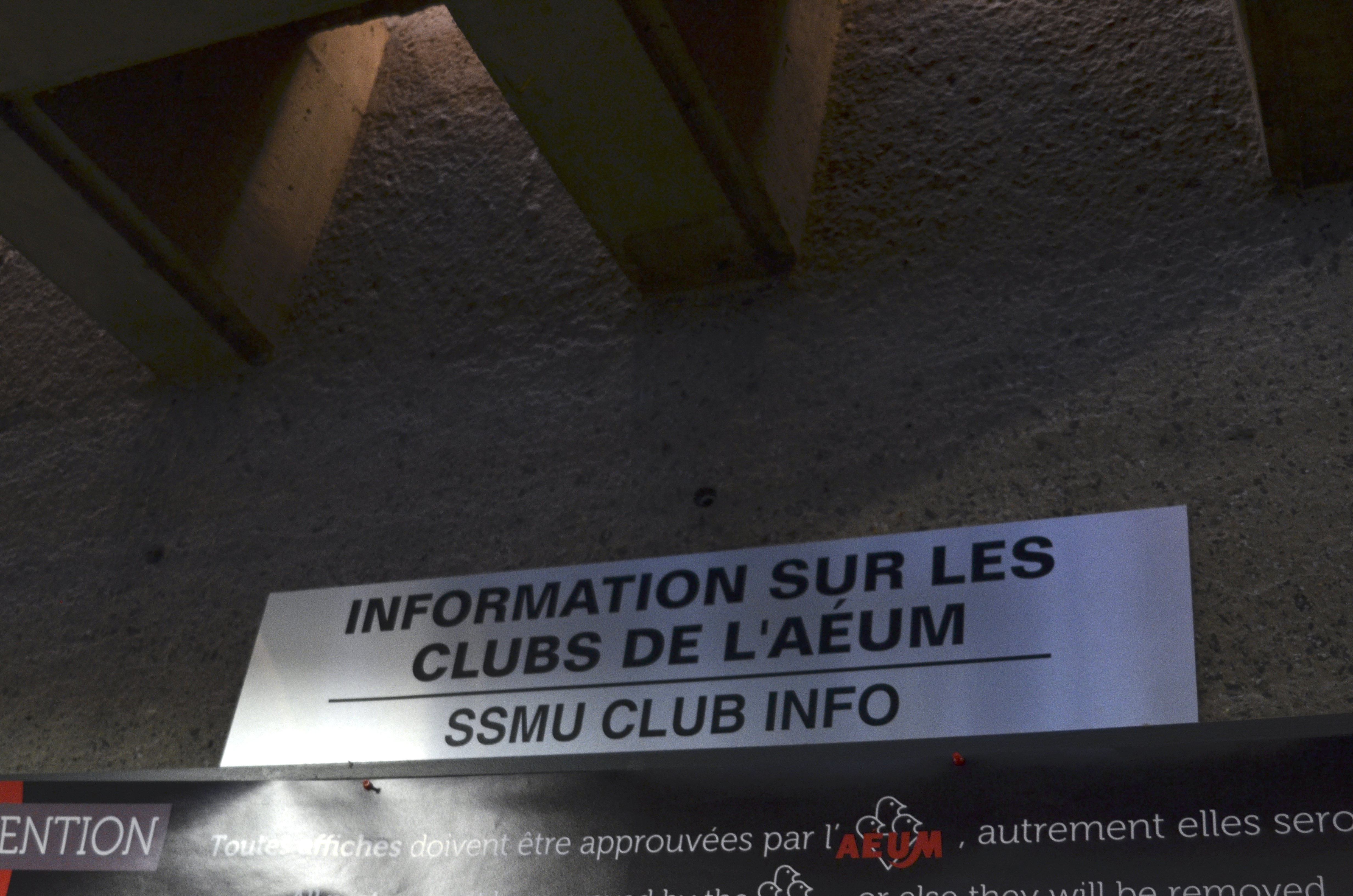 A photograph of the clubs info sign in the Shatner building that says "Information Sur Les Clubs de L'AEUM"