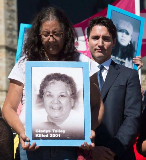 Bridget stands beside Justin Trudeau. Photo courtesy of Yahoo News Canada.