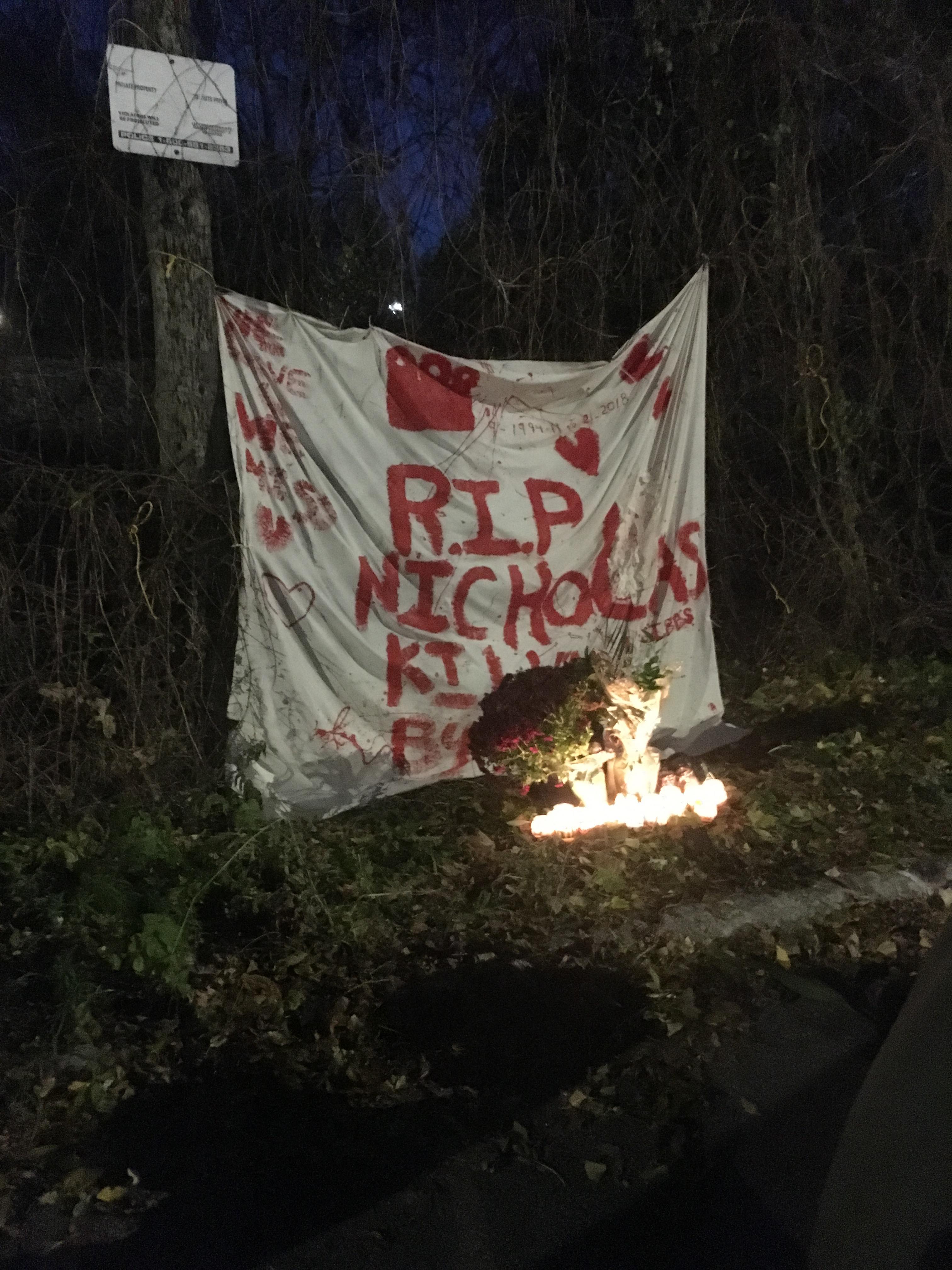 Banner along a fence along the train tracks at Maisonneuve and Montclair, NDG (spot where Gibbs was killed). The banner reads RIP Nicholas. Candles are lit below the banner.