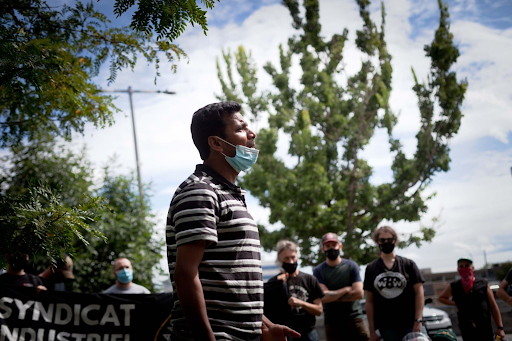 Former warehouse worker Gaurav Sharma performs a short play about his Dollarama experience at a protest in August